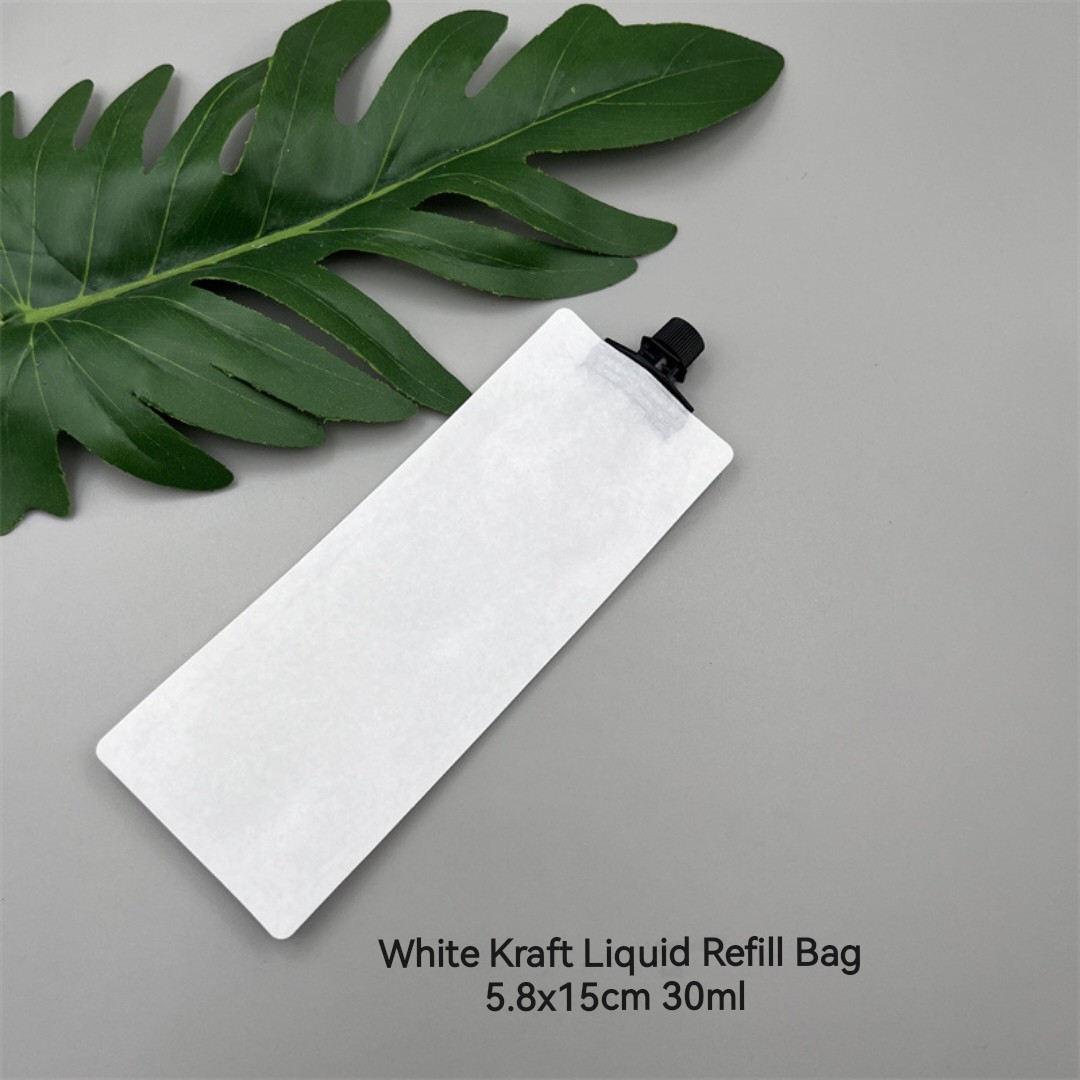 White refill pouch with black cap photographed with a leaf